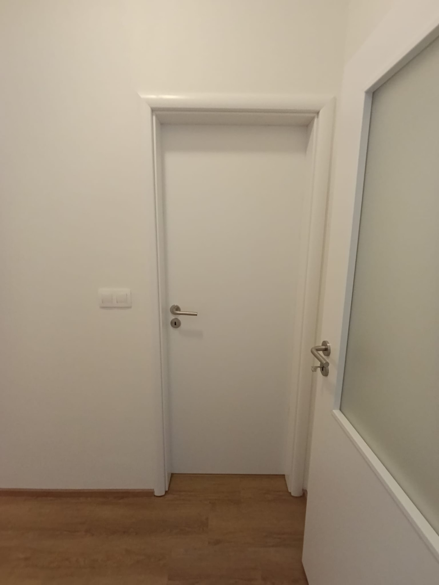 Detail natřených dveří a zárubně po výmalbě bytu na Praze 2